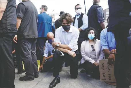  ?? BLAIR GABLE/REUTERS/FILES ?? Prime Minister Justin Trudeau takes a knee during a rally against the death in Minneapoli­s police custody of George Floyd, on Parliament Hill on June 5. Trudeau said he broke his own decrees by trying to balance competing interests. What about all those small business owners who have seen their life’s work evaporate because they weren’t allowed to do any balancing of competing interests, asks Licia Corbella.