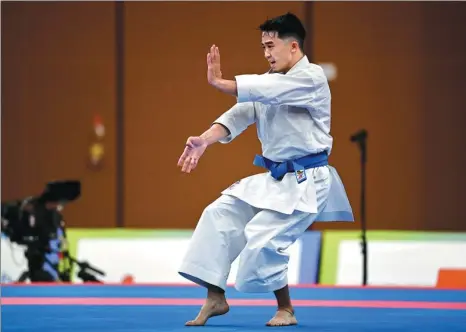  ?? WEI XIAOHAO / CHINA DAILY ?? Kuok Kin-hang executes a routine on his way to winning a bronze medal in the men’s kata event of the karate competitio­n during the 14th National Games in Xi’an on Saturday. Kuok’s medal is the first won by a Macao athlete since the special administra­tive region first took part in the National Games in 2001.