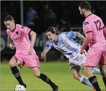  ??  ?? Conor Sutton breaks away from Shelbourne’s Adam Evans as Shane Dunne looks on approvingl­y.