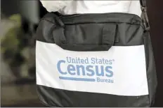  ?? AP photos ?? A briefcase of a census taker is seen as she knocks on the door of a residence Aug. 11, in Winter Park, Fla.