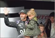  ?? AP - Will Lester, file ?? Jimmie Johnson is introduced as he carries his youngest daughter, Lydia, while his oldest daughter, Genevieve, and wife, Chandra, follow before a March race in California.