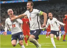  ?? Laurence Griffiths / Associated Press ?? England’s Harry Kane (center) celebrates with his teammates after scoring the gamewinner in the 104th minute.