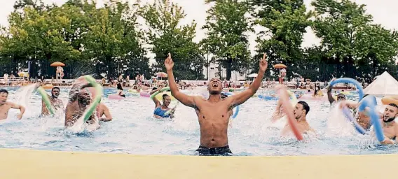  ?? Warner Bros. ?? The pool scene in “In the Heights” features Corey Hawkins as Benny, center, other lead actors and hundreds of extras.