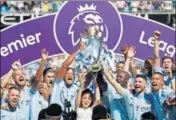  ?? REUTERS PHOTO ?? Manchester City were handed the Premier League trophy at the Etihad Stadium on Sunday.