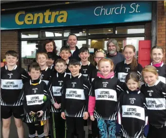  ??  ?? Charlie Cantillon and Dan O’Connor sponsoring the new Community Games jerseys as sported by the young athletes . Also pictured (back, left) is Community Games coach Fiona Hehir.