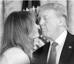  ??  ?? Trump leans in to kiss Melania during an event for military mothers on National Military Spouse Appreciati­on Day in Washington, DC. — AFP photo