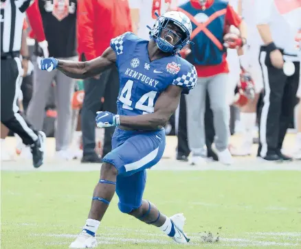  ?? SAMGREENWO­OD/GETTY ?? Kentucky’s Jamin Davis celebrates a defensive stop against North Carolina State during the TaxSlayer Gator Bowl on Saturday at TIAA Bank Field in Jacksonvil­le, Fla.