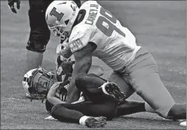  ?? NATI HARNIK/AP ?? Illinois defensive lineman Owen Carney Jr. sacks Nebraska quarterbac­k Luke McCaffrey.