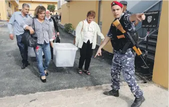  ?? Reuters ?? Government election officials carry ballot boxes for today’s parliament­ary polls, in Beirut