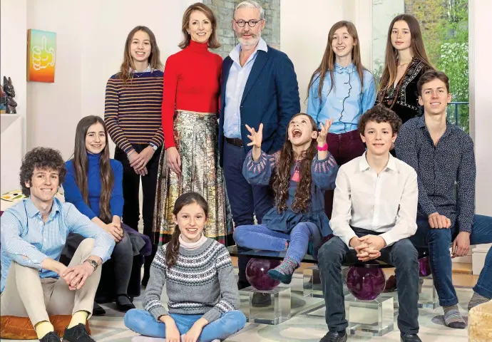  ??  ?? We are family: Helena and Richard Morrissey, centre, with their nine children – standing from left, Millie, 18, Clara, 17, and Flo, 23. Sitting from left, Fitz, 26, Octavia, 14, Cecily, ten, Bea, eight, Theo, 12, and Tuppy, 19. While Helena climbs the heights in the City, Richard has held the fort at home for two decades