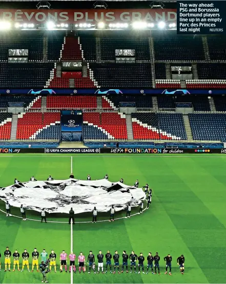  ?? REUTERS ?? The way ahead: PSG and Borusssia Dortmund players line up in an empty Parc des Princes last night