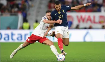  ?? Photograph: Mike Hewitt/Fifa/Getty Images ?? Poland’s Matty Cash fought hard against Kylian Mbappé but was unable to prevent him scoring twice.