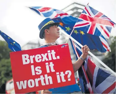  ?? Picture: REUTERS ?? PRO EU: An anti-Brexit demonstrat­or waves flags outside the Houses of Parliament in London on Monday