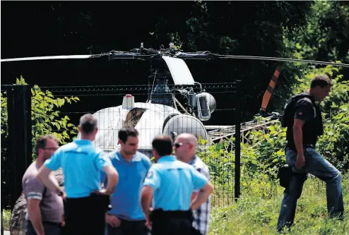  ?? GEOFFROY VAN DER HASSELT / AFP / GETTY IMAGES ?? This picture taken Monday in Gonesse, north of Paris, shows police near a French helicopter Alouette II abandoned by French armed robber Redoine Faïd after his dramatic escape from prison in Reau.