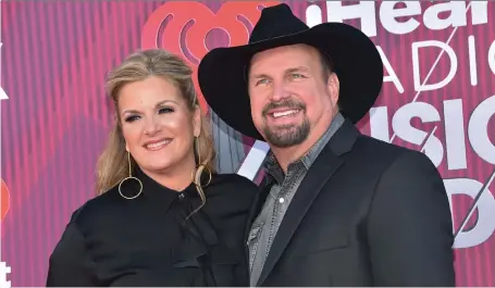  ?? CHRIS DELMAS/ GETTY IMAGES ?? Country music stars Trisha Yearwood and Garth Brooks have a strong personal and profession­al partnershi­p.