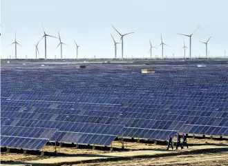  ?? REUTERS ?? CATCH THE RAYS A solar/ wind turbine plant in Hami, Xinjiang province