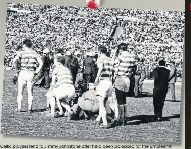  ??  ?? Celtic players tend to Jimmy Johnstone after he’d been poleaxed for the umpteenth time against Racing Club in Montevideo. Meanwhile, in the background riot police react to yet another incident as the match descends into chaos