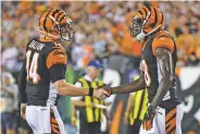  ?? BRYAN WOOLSTON ASSOCIATED PRESS ?? Bengals quarterbac­k Andy Dalton, left, celebrates with wide receiver A.J. Green after scoring a touchdown during Thursday’s game in Cincinnati. Dalton threw four TD passes, three of which were to Green.