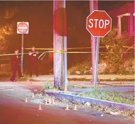  ?? KENNETH K. LAM/BALTIMORE SUN ?? Baltimore police officers investigat­e the scene of a shooting on the 4200 block of Pimlico Avenue Monday. That day, nine people were shot — three fatally — in the northweste­rn area of Baltimore. Another two people were shot Thursday in the area.