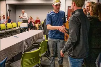  ?? ?? BOCES student Daniel Karl left, shakes hands with Casey Balzer, assistant Albany branch manager with Kamco Supply New England, on Thursday in Latham.