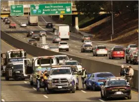  ?? (File Photo/AP/Rich Pedroncell­i) ?? A police officer riding a motorcycle was killed Jan. 21, 2022, after being struck by a man driving the blue car the wrong way on southbound Highway 99 in Sacramento, Calif.