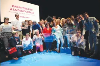  ??  ?? Deputies of the Catalan Parliament pose with ballot boxes after the presentati­on of the details of the Oct. 1 referendum, in Barcelona on Tuesday. (AFP)