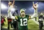  ?? MIKE ROEMER — THE ASSOCIATED PRESS ?? Green Bay Packers’ Aaron Rodgers celebrates as he walks off the field after an NFL divisional playoff football game against the Seattle Seahawks Sunday in Green Bay, Wis. The Packers won 28-23 to advance to the NFC Championsh­ip.