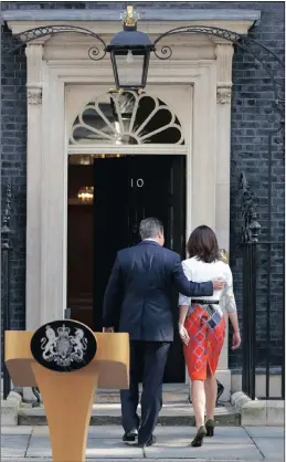  ??  ?? BACKING OFF: Britain’s Prime Minister David Cameron puts his arm around his wife Samantha after speaking outside 10 Downing Street yesterday. Cameron says he will resign by the time of the party conference later this year after Britain voted to leave...