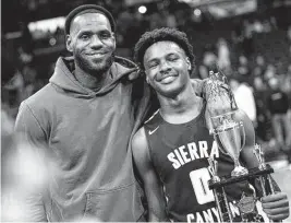  ?? JAY LAPRETE AP ?? LeBron James, left, poses with his 16-year-old son Bronny, who is a 6-4 point guard for Sierra Canyon in Los Angeles and is ranked the No. 49 junior in the nation.