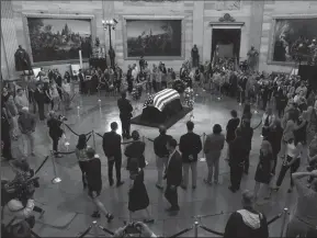  ?? OLIVIER DOULIERY/ABACA PRESS ?? Visitors pay their respects near the casket of the late U.S. Sen. John McCain laid in honor at the U.S. Capitol Rotunda on Friday in Washington, D.C.