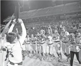  ?? ?? Pocola celebrates with the trophy after the beating Morrison 9-3 Tuesday night in the Class 3A slowpitch softball state championsh­ip game.
