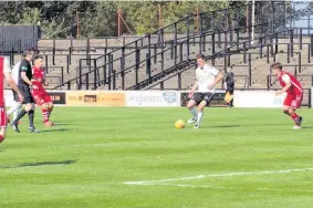  ??  ?? Big presence
Jack Baird gets on the ball during the second half