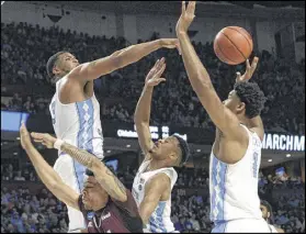  ?? CHUCK LIDDY / RALEIGH NEWS & OBSERVER ?? North Carolina’s Kennedy Meeks (top left) blocks a shot by Texas Southern’s Zach Lofton, who gets swarmed by defenders during the Tar Heels’ 103-64 victory.