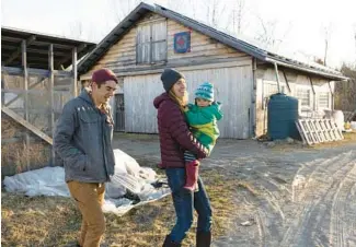  ?? BRIANNA SOUKUP/FOR THE WASHINGTON POST ?? Adam Nordell, Johanna Davis and their son at Songbird Farm in Unity, Maine, on March 22. The couple bought their farm seven years ago but suspended operations in late 2021 after discoverin­g their land and water is contaminat­ed with high levels of forever chemicals, also known as per- and polyfluoro­alkyl substances or PFAS.