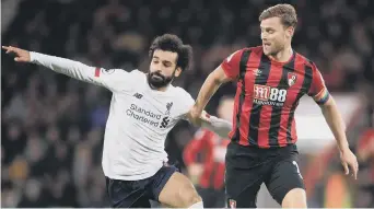  ??  ?? Simon Francis (right) playing for Bournemout­h against Liverpool’s Mo Salah.