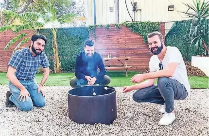  ?? PROVIDED BY SPRUCE ?? Spruce executives Jason Cunningham, from left, Paul Clark, and founder and CEO Ben Johnson, roast marshmallo­ws outside their headquarte­rs during a recent happy hour. The Austin, Texas-based startup is among companies debating whether to continue perks such as snacks and meals as several employees return to the office.