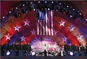  ?? AP FILE ?? Keith Lockhart, center, conducts The Boston Pops orchestra during rehearsal for the annual Boston Pops Fireworks Spectacula­r on the Esplanade, on July 3, 2017, in Boston. This year it will once again perform at the Esplanade with a crowd.