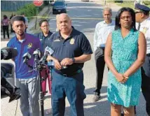  ?? JESSICA ANDERSON/BALTIMORE SUN ?? Baltimore Police Commission­er Michael Harrison, center, talks to reporters outside Mervo High School on Friday as police investigat­ed a fatal shooting of a student shortly after dismissal.