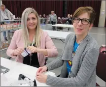  ?? NEWS PHOTO GILLIAN SLADE ?? At the first Alberta Health Services flu vaccine clinic of the season in Medicine Hat, (left) Laurie Pristie RN prepares a needle with Dr. Lena Derie-Gillespie, medical officer of health in the AHS south zone, sitting next to her.