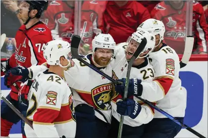  ?? ALEX BRANDON — THE ASSOCIATED PRESS ?? Florida Panthers defenseman Gustav Forsling, right wing Claude Giroux, center Carter Verhaeghe and center Aleksander Barkov, from left, celebrate Giroux’s goal against the Washington Capitals during Game 6of a first-round series Friday.