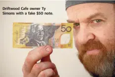  ??  ?? Driftwood Cafe owner Ty Simons with a fake $50 note.