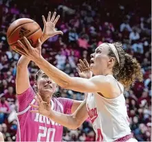  ?? Darron Cummings/Associated Press ?? Indiana’s Grace Berger shoots against Iowa’s Kate Martin in the the second half of the Hoosiers’ victory in Bloomingto­n, Ind.