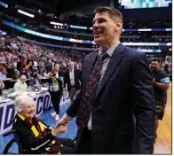  ?? AP/TONY GUTIERREZ ?? Loyola-Chicago Coach Porter Moser is greeted by Sister Jean Dolores Schmidt (left) after the Ramblers’ 63-62 victory over Tennessee on Saturday at the South Region of the men’s NCAA Tournament in Dallas.