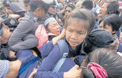  ??  ?? POLICE INTERVENTI­ON: Officers struggle to contain people from a group called the ‘People Go Network’ as they try to break through a cordon in front of Thammasat University’s Rangsit campus yesterday.