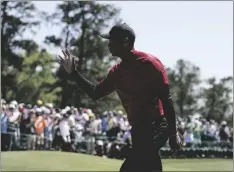  ?? AP PHOTO/JAE C. HONG ?? Tiger Woods waves to spectators on the 18th green after his final round at the Masters golf tournament on Sunday in Augusta, Ga.