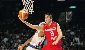  ?? EDUARDO VERDUGO/THE ASSOCIATED PRESS ?? Canada’s Nik Stauskas gets past Puerto Rico’s Ramon Clemente for a layup Friday. Canada won 112-92.