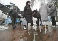  ?? ?? Local residents queue in line for access to a water pump in a park to fill plastic bottles in Kyiv, on Thursday, amid the Russian invasion of Ukraine.