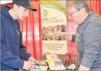  ?? ERIC MCCARTHY/JOURNAL PIONEER ?? Joel Matthews looks for guidance from red seal electricia­n and Skills Canada youth outreach coordinato­r Rosemary Crane during a try-a-trade demonstrat­ion at the Western P.E.I. Job Fair.
