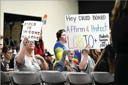 ?? ANJALI SHARIF-PAUL / THE ORANGE COUNTY REGISTER VIA AP ?? Parents, students and staff of Chino Valley Unified School District hold up signs in favor of protecting LGBTQ+ policies at Don Antonio Lugo High School in June 2023. The school district approved changes on Thursday to a policy that required school staff to notify parents if their child asks to change pronouns at school. The updated policy passed by the board removes mentions of student gender identifica­tion changes.