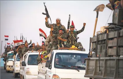  ?? AFP via Getty Images ?? Syrian government forces drive along a road in the countrysid­e of the northeaste­rn Syrian city of Qamishli on Friday. Damascus and Moscow deployed extra forces to Syria’s border with Turkey, even as Washington partially reversed a drawback to boost its own military presence near key Syrian oil fields.